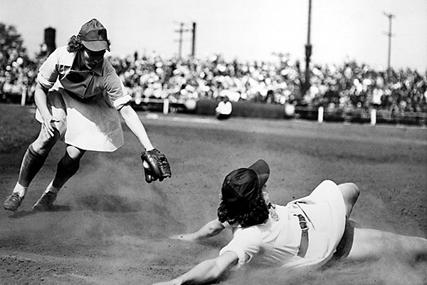 1943 women's baseball player sliding on base, skirt first